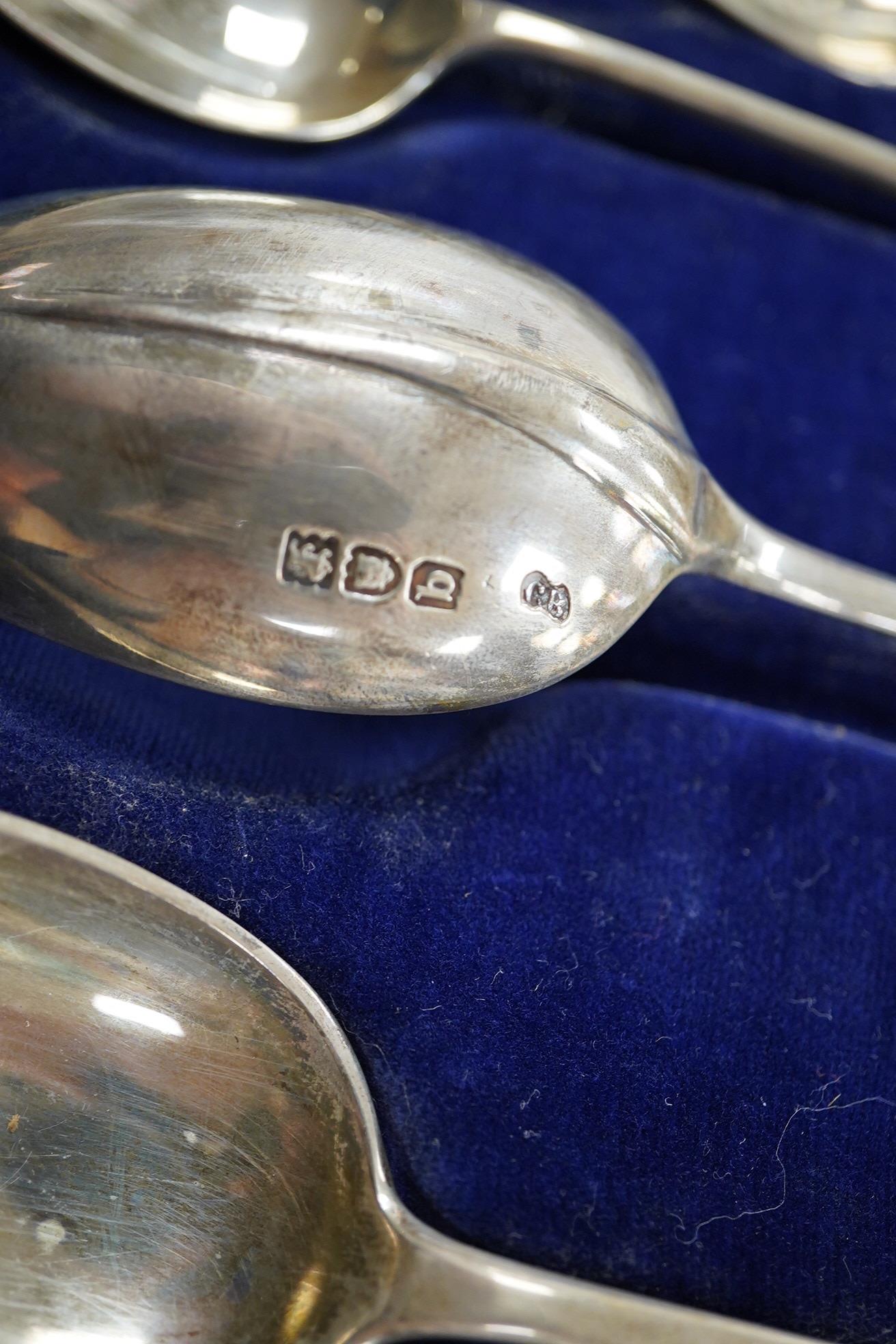 A cased set of George V silver spoons, the terminals with the crest of The Worshipful Company of Joiners and Ceilers, of two different sizes, 17.1cm and 12.9cm, various dates and makers including Elkington & Co, 11.4oz.